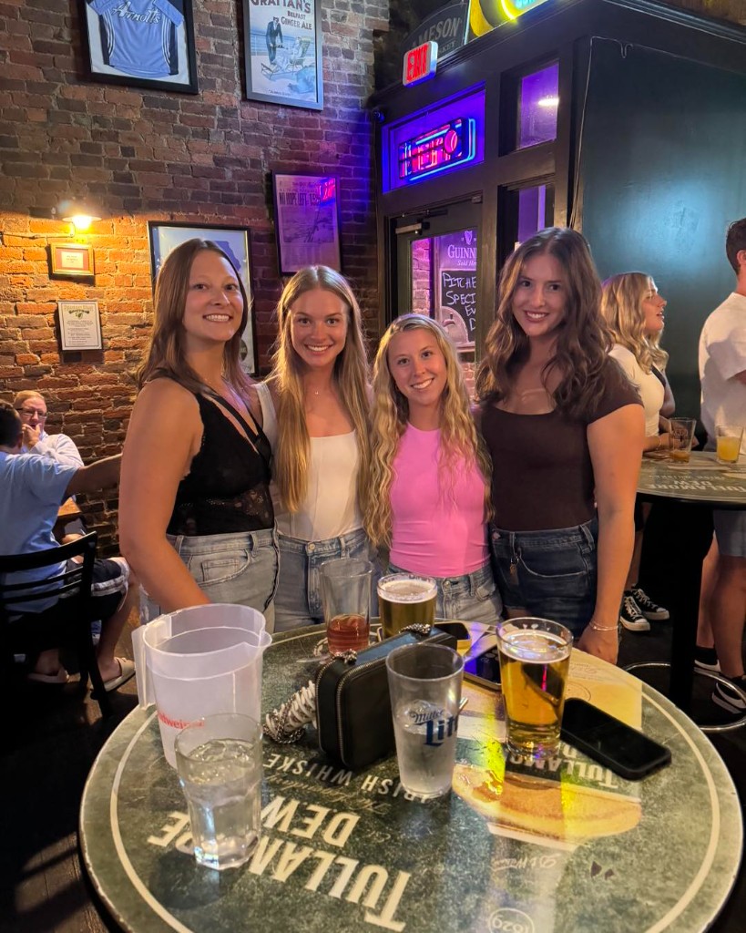 Friends gathered at a high-top table inside Finnegan's Wake